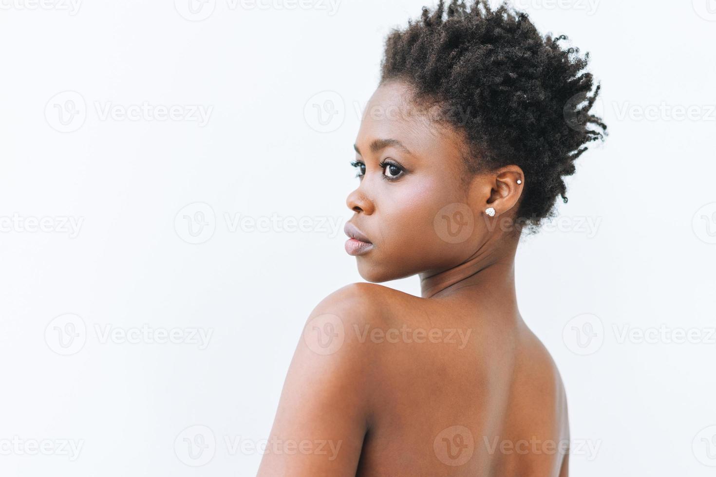 Beauty portrait of beautiful young African American woman in black top isolated on the white background photo