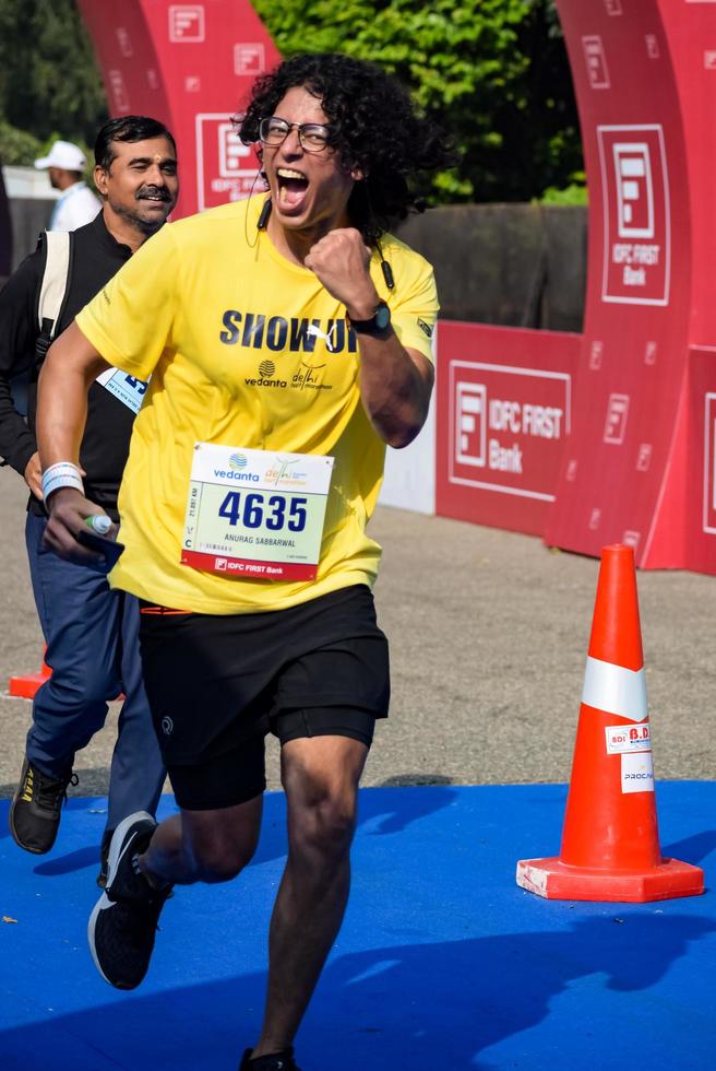 New Delhi, India - October 16 2022 - Vedanta Delhi Half Marathon race after covid in which marathon participants about to cross the finish line, Delhi Half Marathon 2022 photo