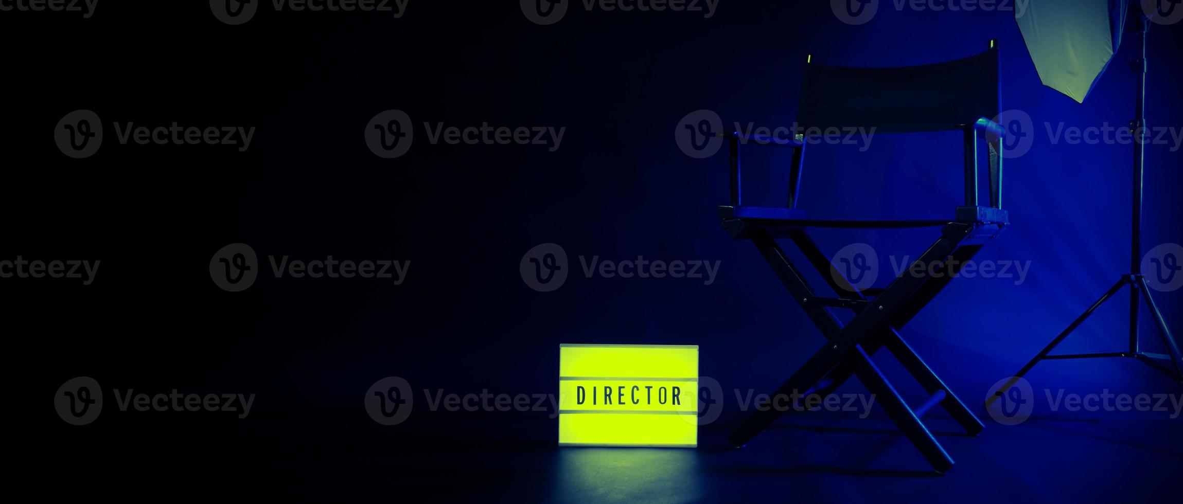 Director chair with cinema lightbox sign Director text on it and clapperboard megaphone photo