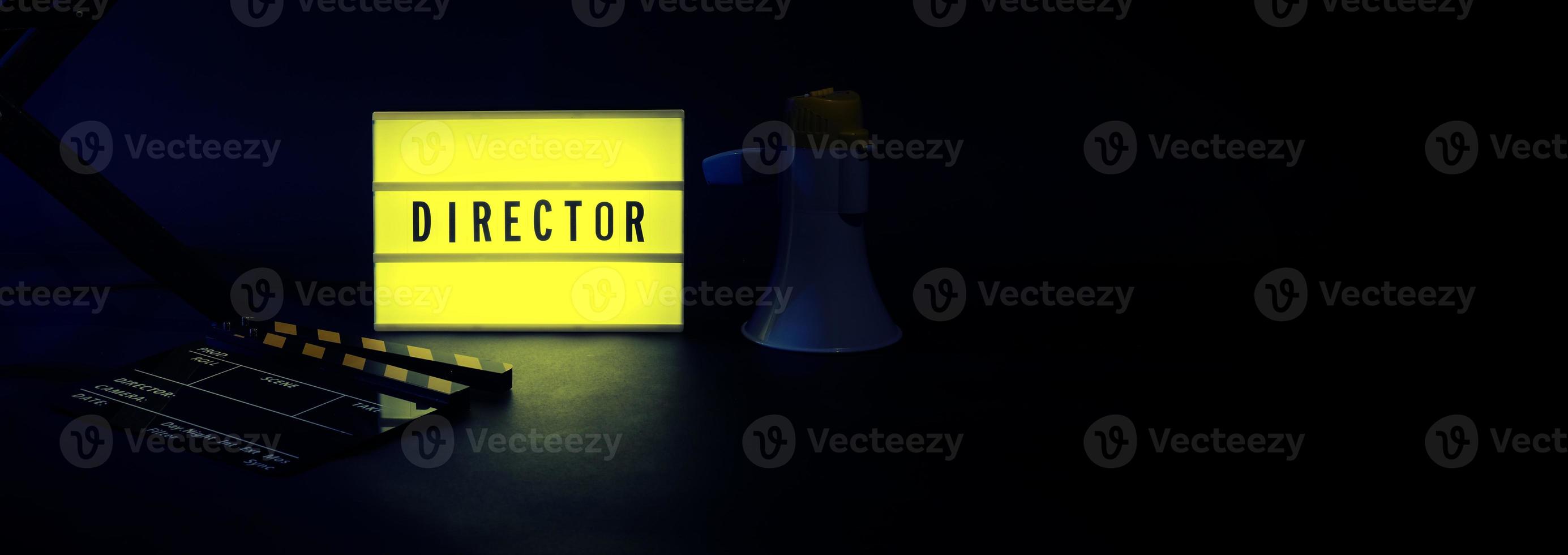 Director chair with cinema lightbox sign Director text on it and clapperboard megaphone photo