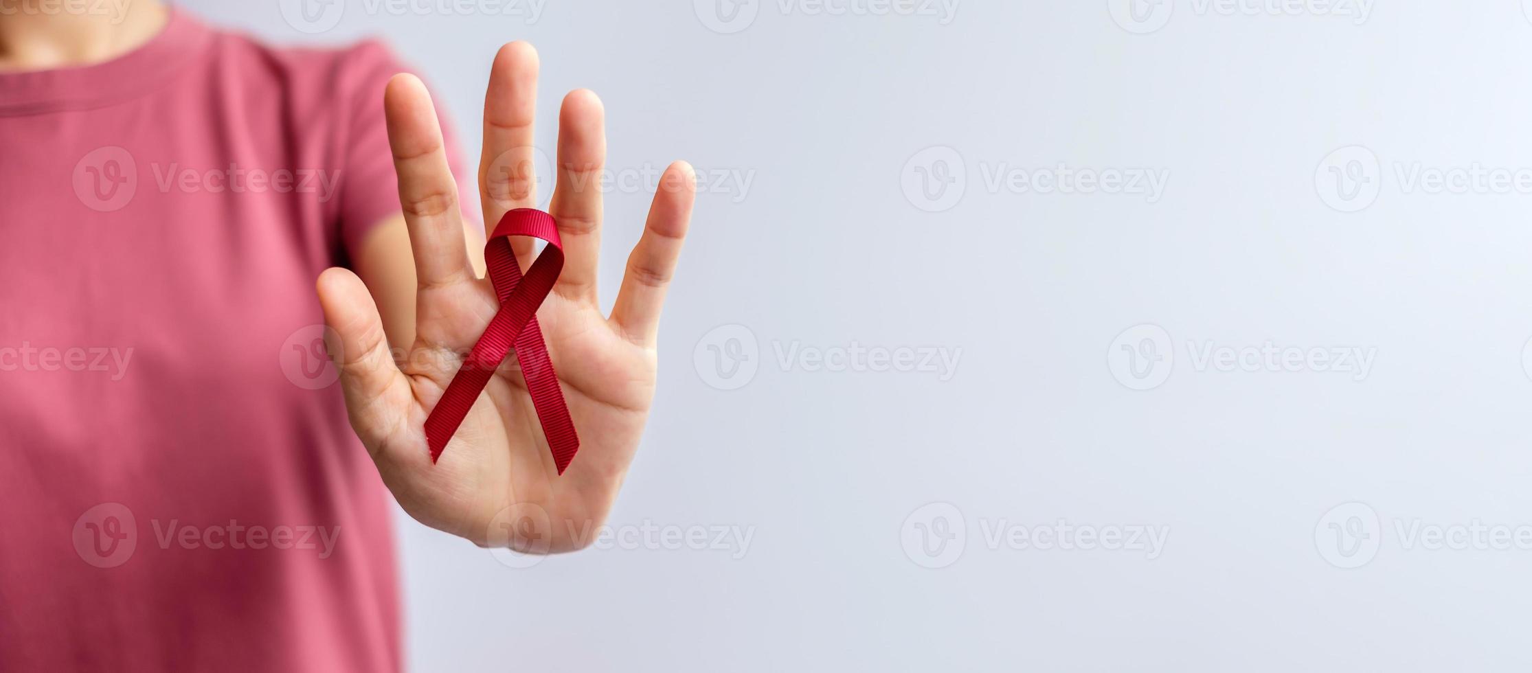 Burgundy Red Ribbon for March multiple myeloma Cancer and December World Aids Day Awareness month. Healthcare and world cancer day concept photo