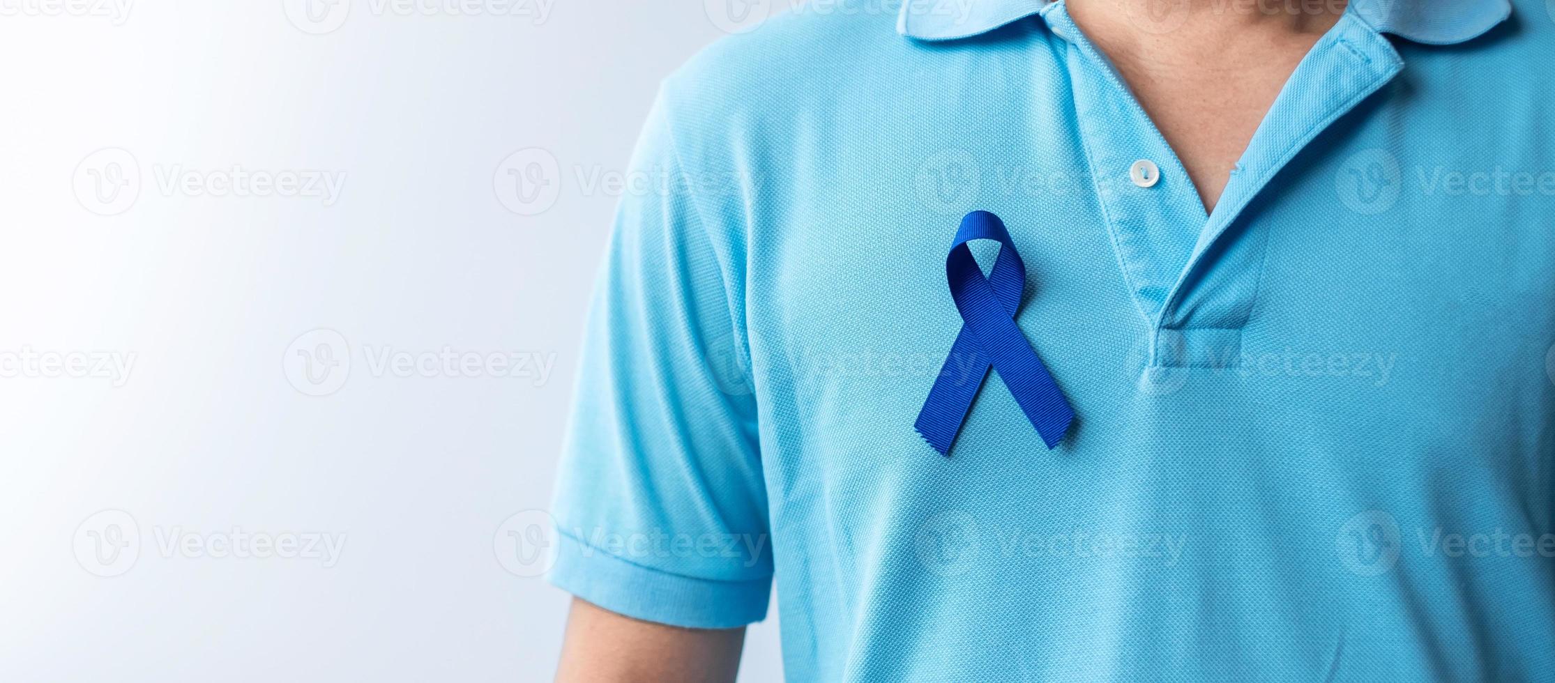 March Colorectal Cancer Awareness month, Woman holding dark Blue Ribbon for supporting people living and illness. Healthcare, hope and World cancer day concept photo