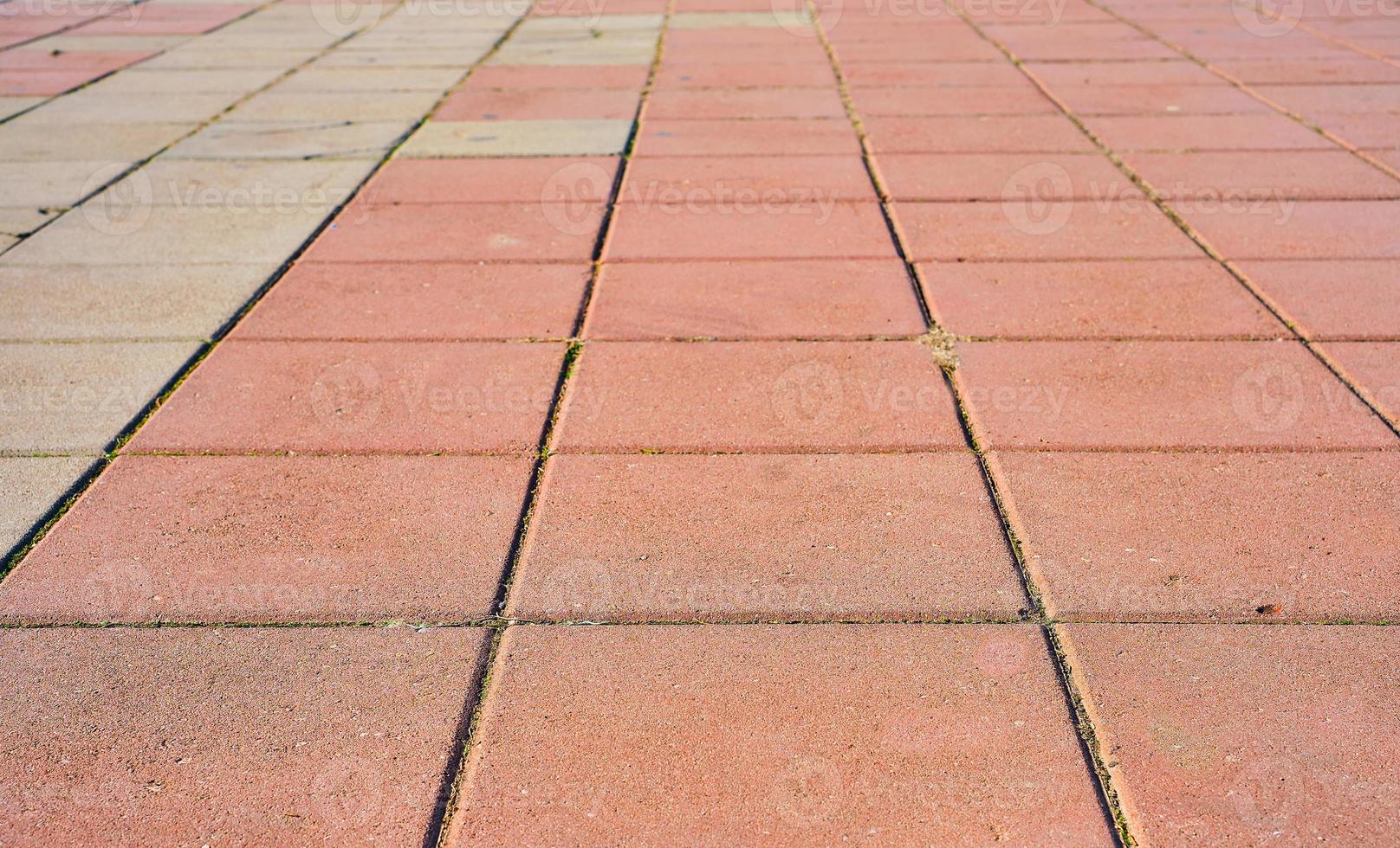 The footpath is paved with multi-colored paving stones. selective focus on paving slabs. photo