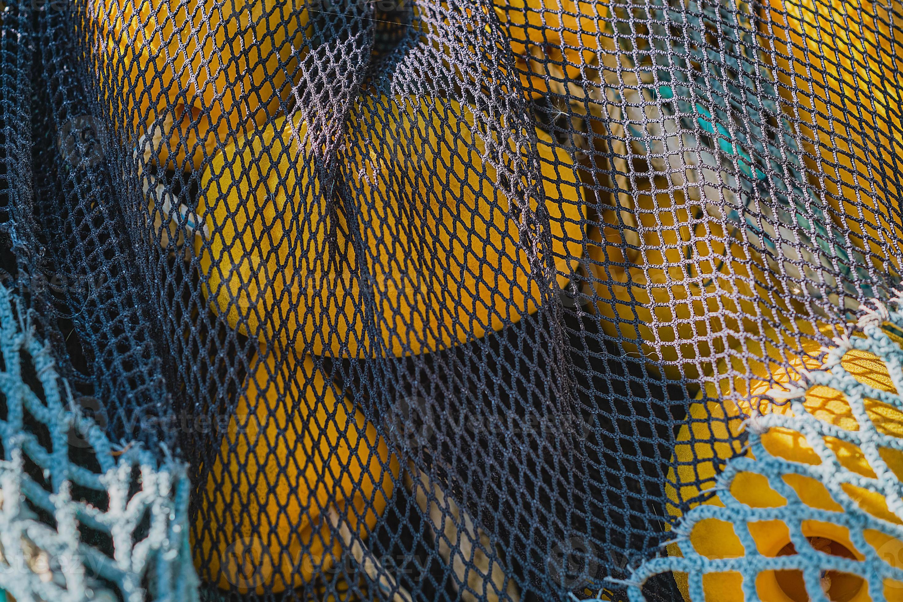 Fishing net with yellow floats dries on the pier, close-up, selective  focus. concepts of fishing in coastal towns 16802656 Stock Photo at Vecteezy