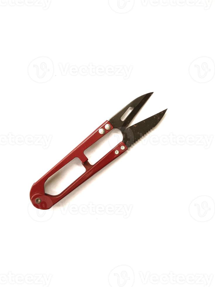 Thread scissors are commonly used by tailors to cut excess thread left over from sewing photo