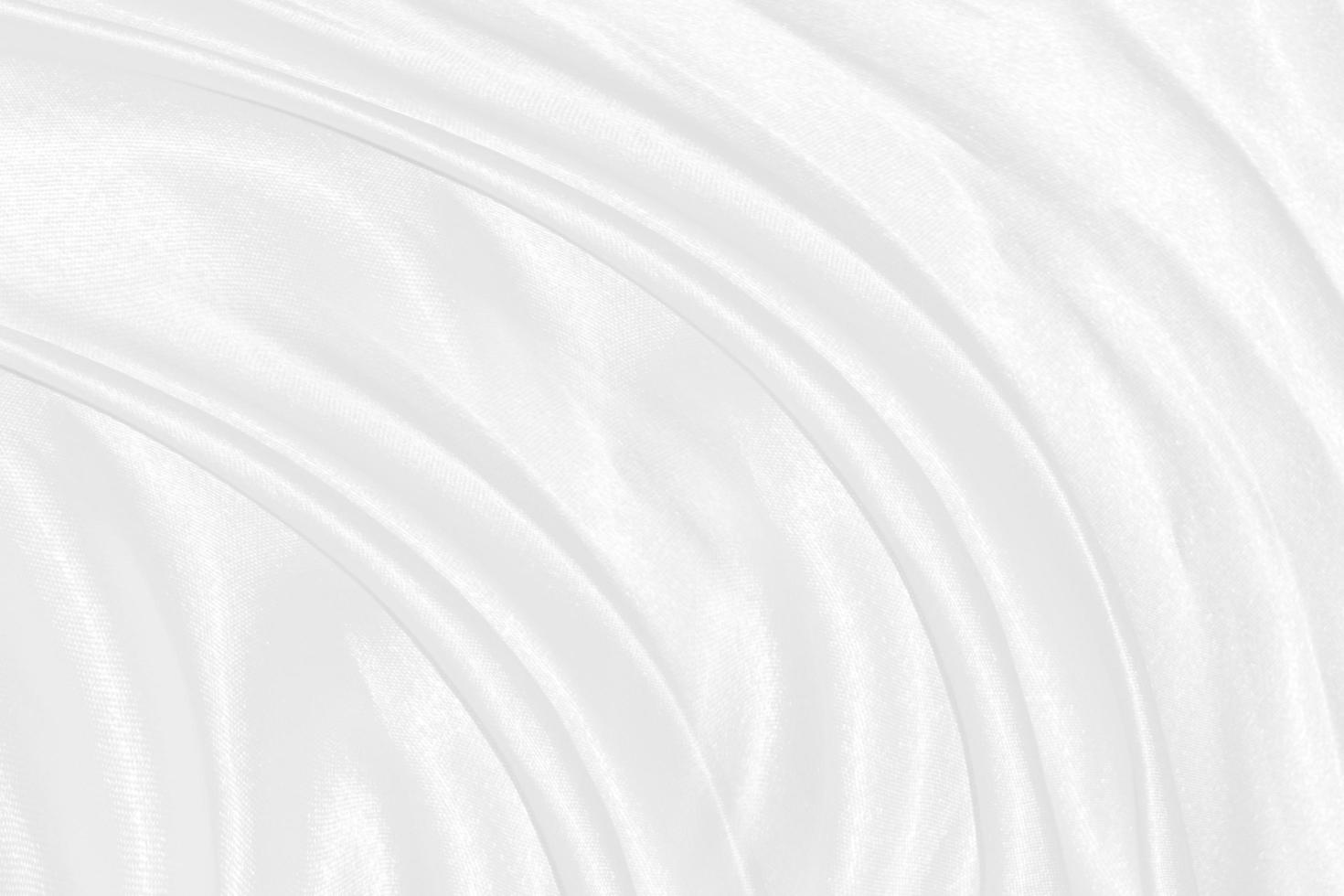Smooth elegant white silk or satin luxury cloth texture can use as wedding background. Luxurious background design photo