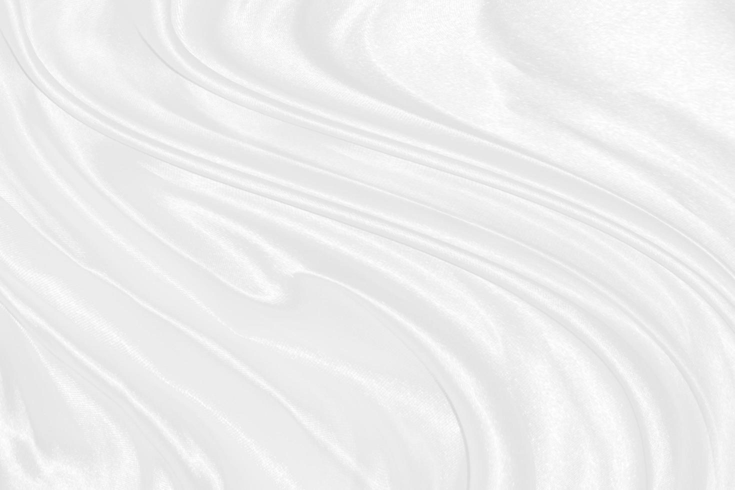 Smooth elegant white silk or satin luxury cloth texture can use as wedding background. Luxurious background design photo