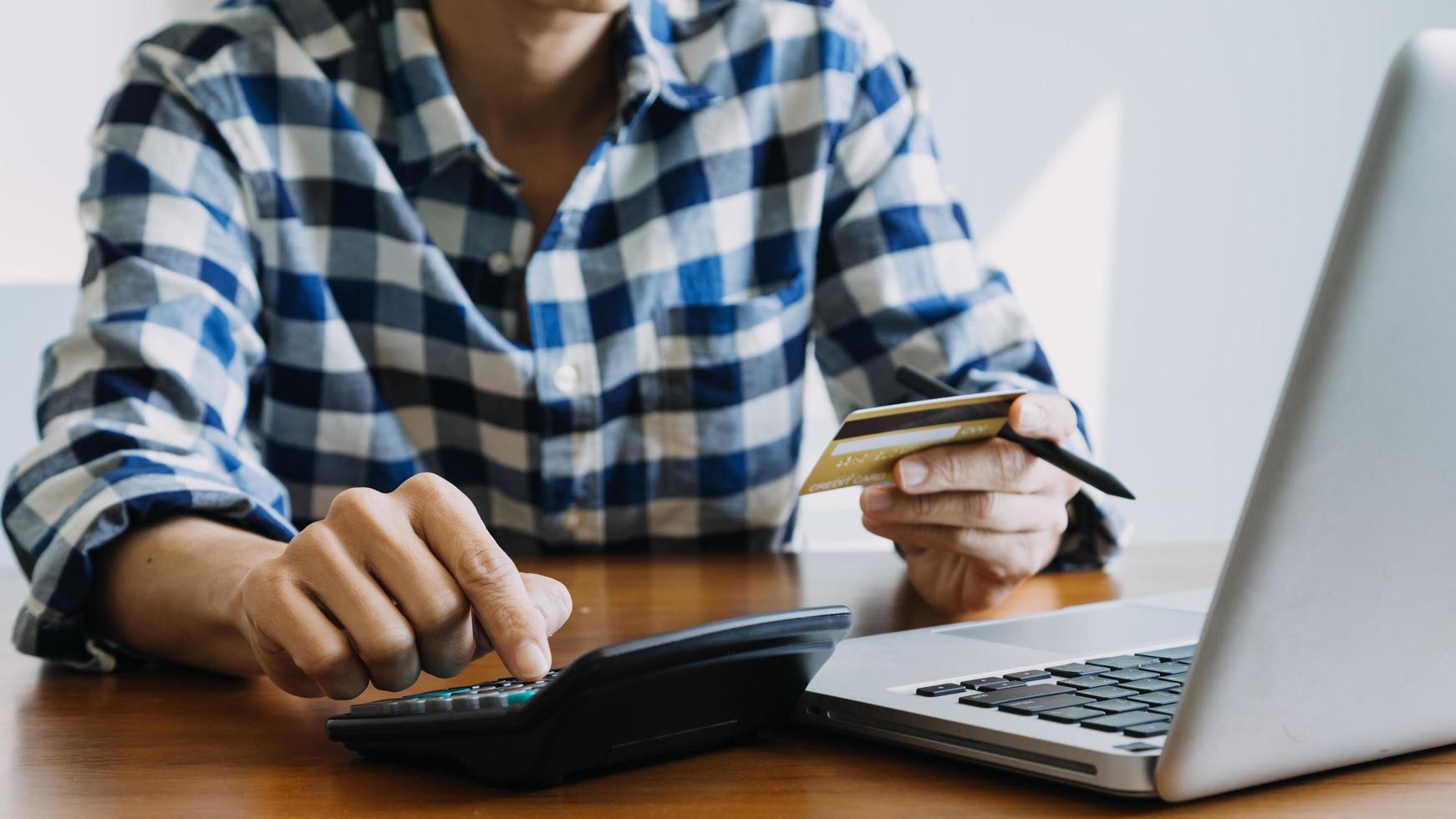 Hands holding credit card and using laptop. Online shopping photo