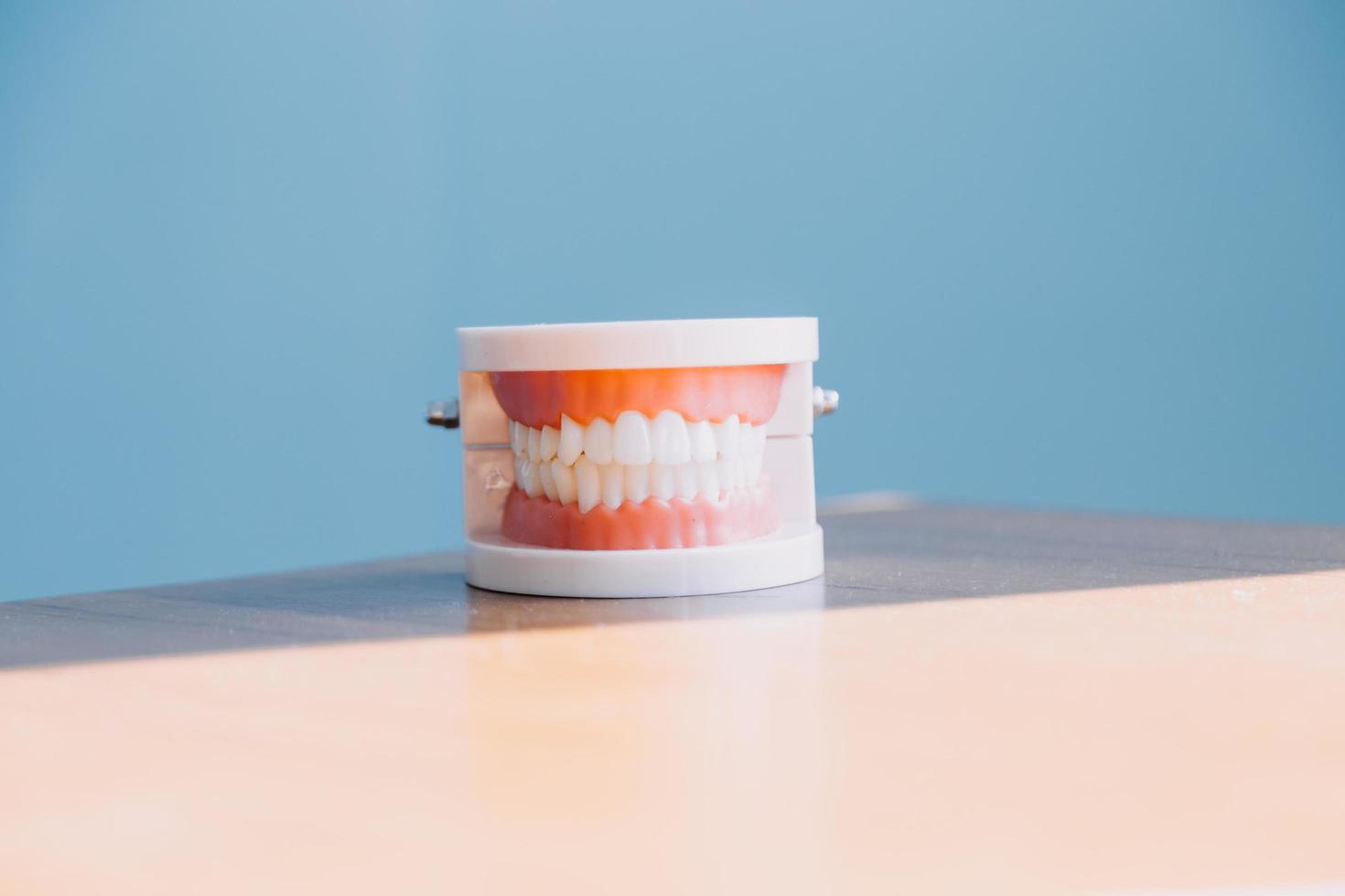 Stomatology concept, partial portrait of girl with strong white teeth looking at camera and smiling, fingers near face. Closeup of young woman at dentist's, studio, indoors photo