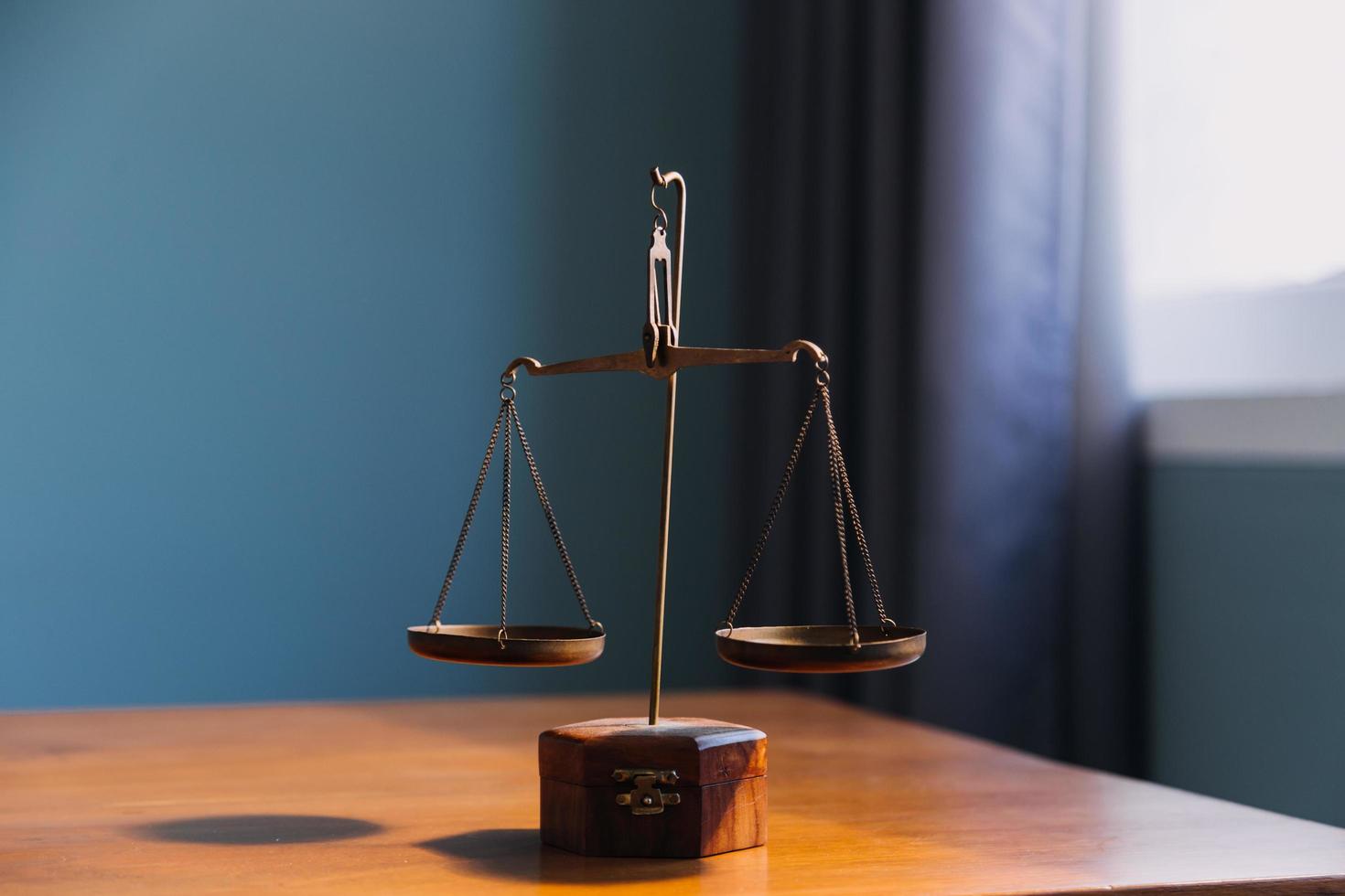 Business and lawyers discussing contract papers with brass scale on desk in office. Law, legal services, advice, justice and law concept picture with film grain effect photo