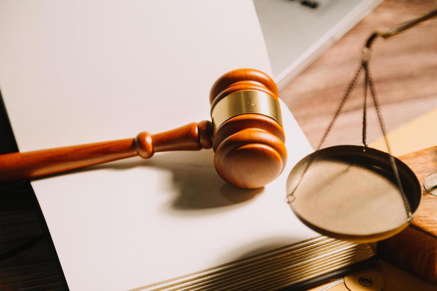 Business and lawyers discussing contract papers with brass scale on desk in office. Law, legal services, advice, justice and law concept picture with film grain effect photo