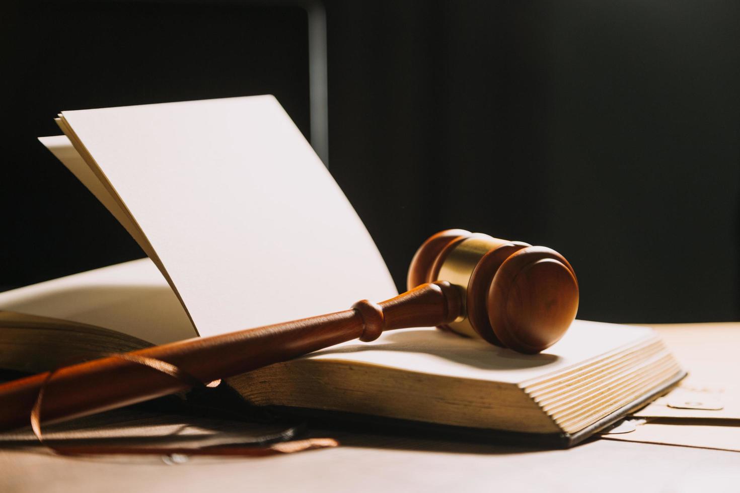 Business and lawyers discussing contract papers with brass scale on desk in office. Law, legal services, advice, justice and law concept picture with film grain effect photo