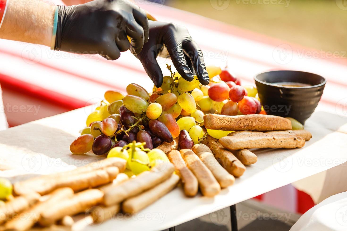 Chef cook prepares dessert with fruit in the restaurant. The concept is healthy food, vegetarianism, vitamins. photo