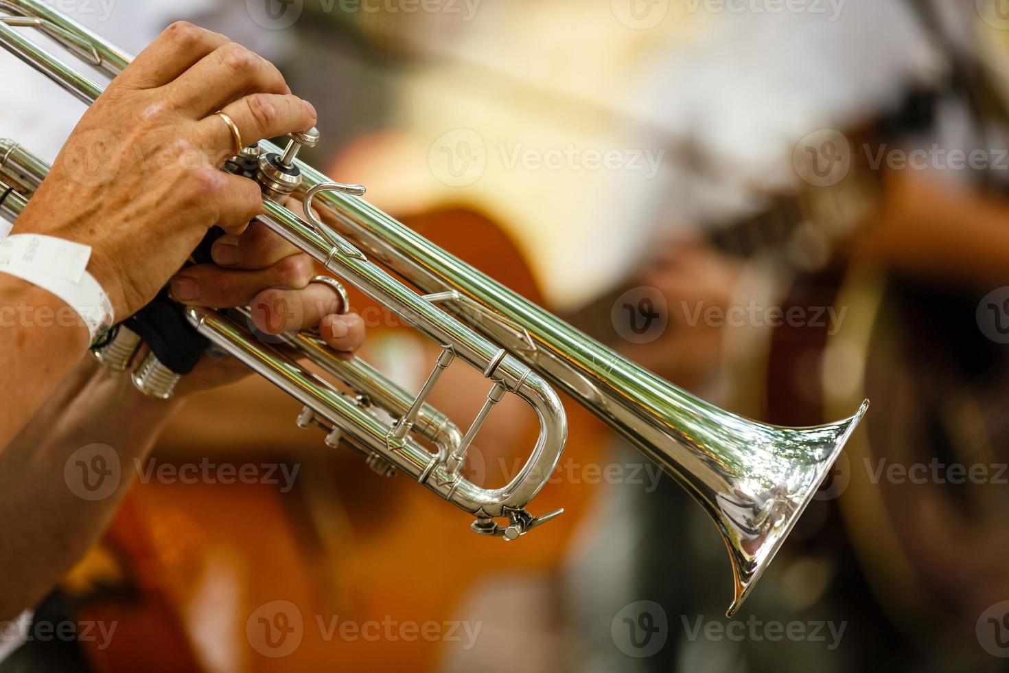 young musicians are playing on trombones photo