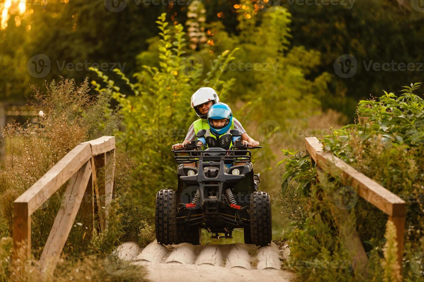 little boy with instructor on a quad bike photo