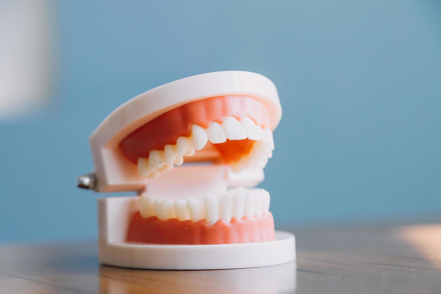 Stomatology concept, partial portrait of girl with strong white teeth looking at camera and smiling, fingers near face. Closeup of young woman at dentist's, studio, indoors photo
