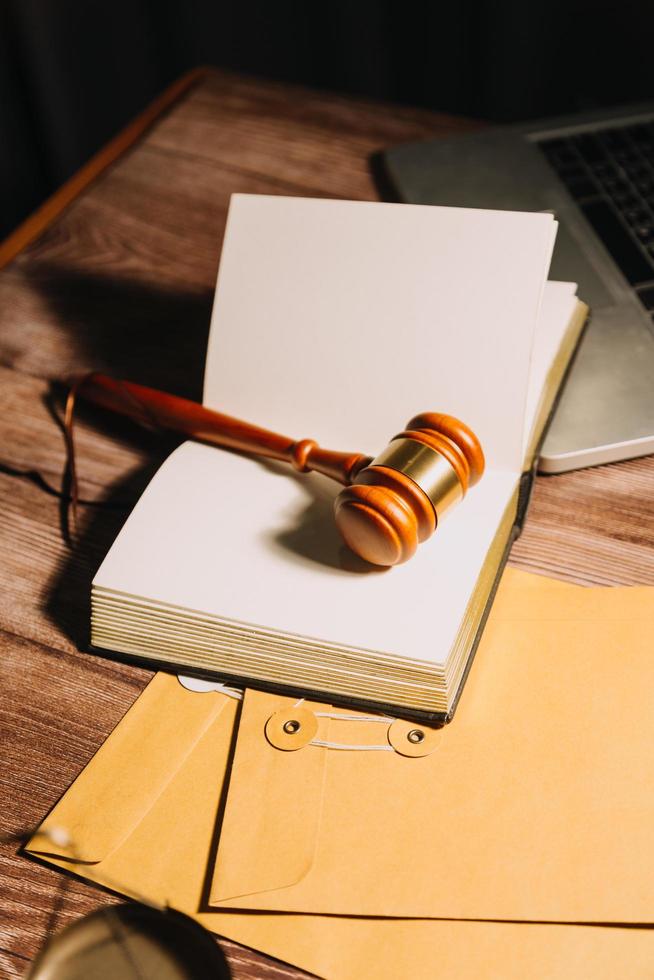 Business and lawyers discussing contract papers with brass scale on desk in office. Law, legal services, advice, justice and law concept picture with film grain effect photo