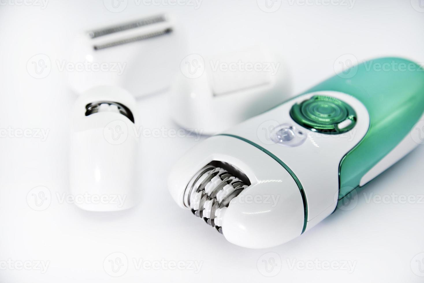 Women's electric razor for intimate places. A set of women's razor for hair on a white background. A white electric razor. photo