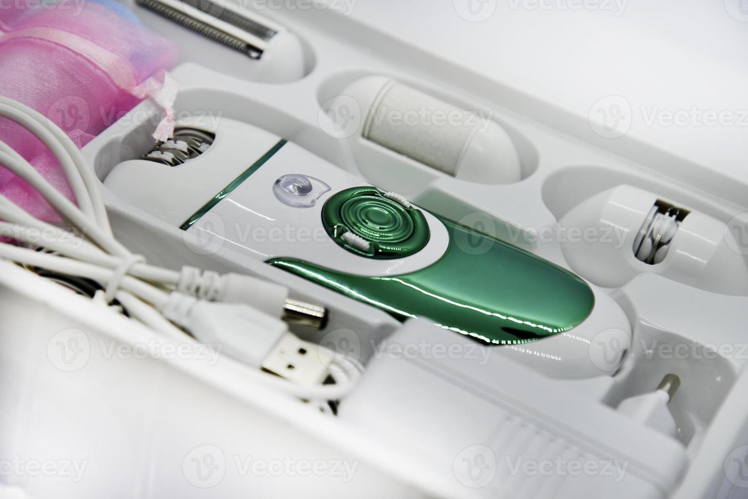 Women's electric razor for intimate places. A set of women's razor for hair on a white background. A white electric razor. photo