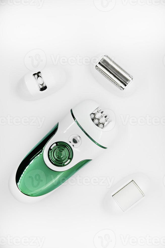 Women's electric razor for intimate places. A set of women's razor for hair on a white background. A white electric razor. photo