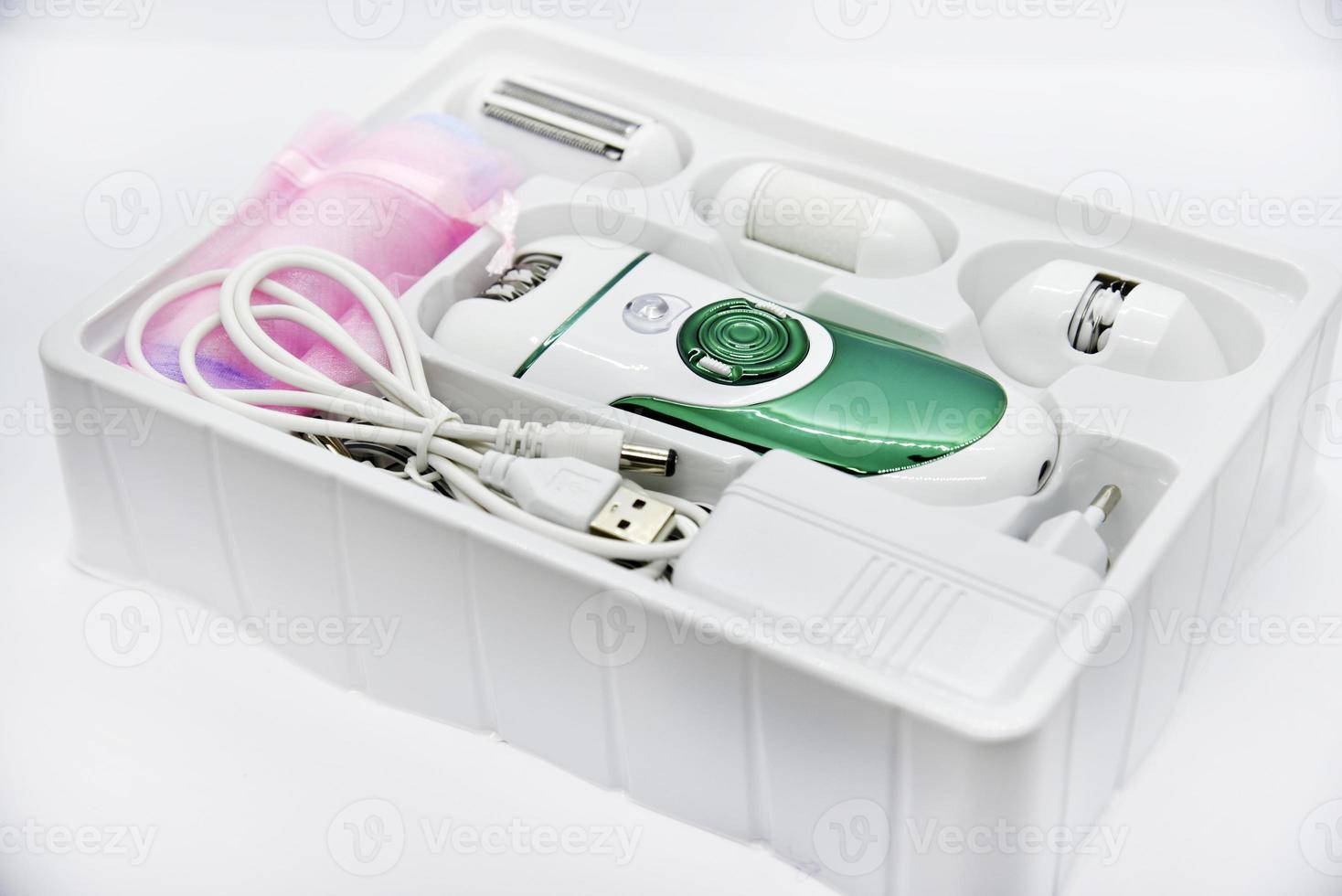 Women's electric razor for intimate places. A set of women's razor for hair on a white background. A white electric razor. photo