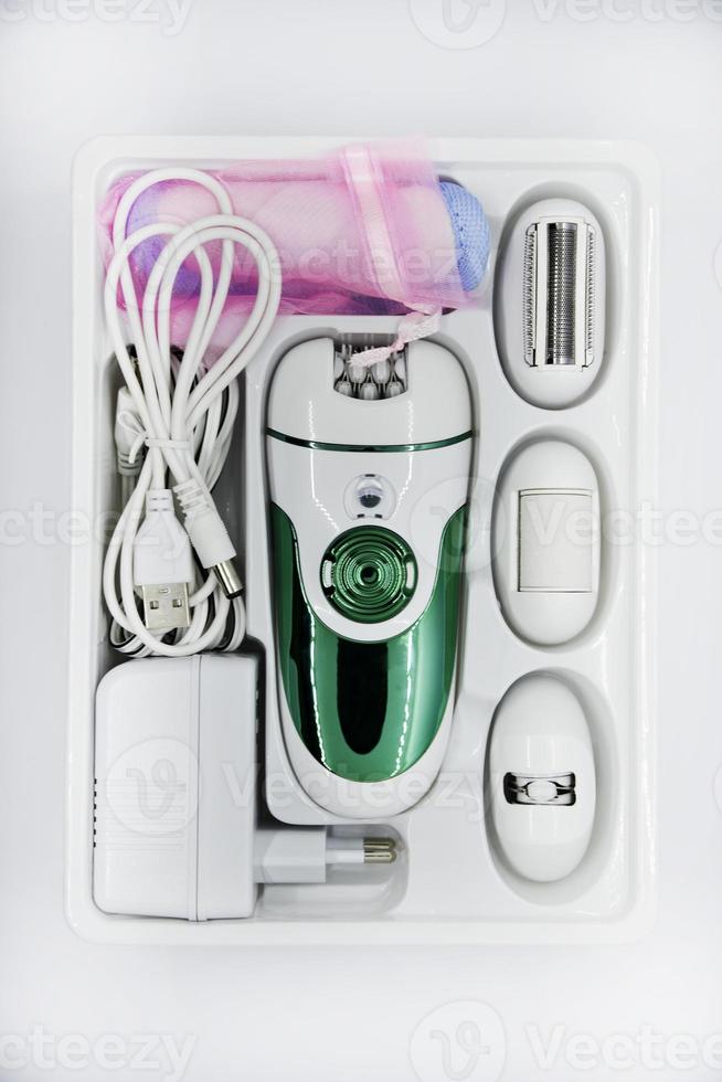 Women's electric razor for intimate places. A set of women's razor for hair on a white background. A white electric razor. photo