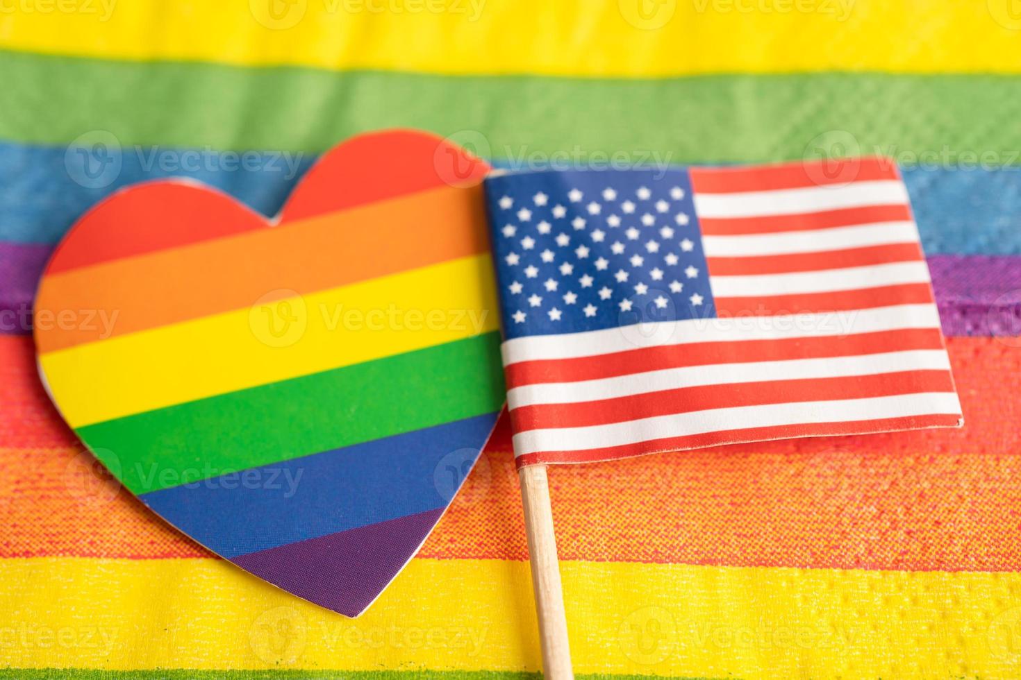 USA America flag on rainbow background symbol of LGBT gay pride month  social movement rainbow flag is a symbol of lesbian, gay, bisexual, transgender, human rights, tolerance and peace. photo