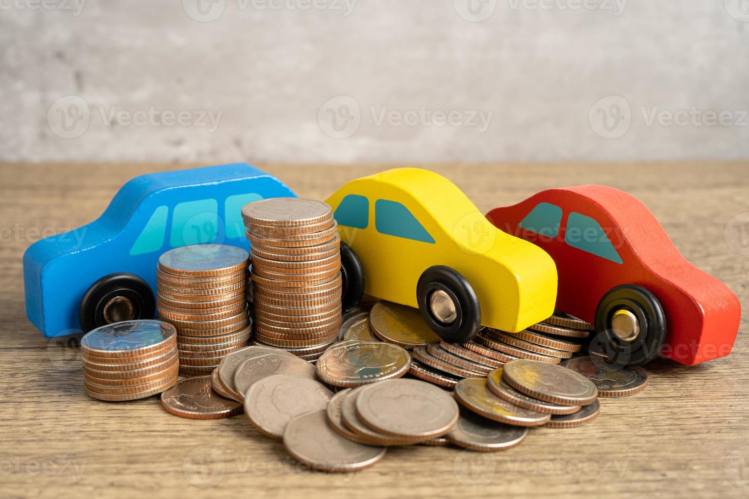 Car on stack of coins. Car loan, Finance, saving money, insurance and leasing time concepts. photo