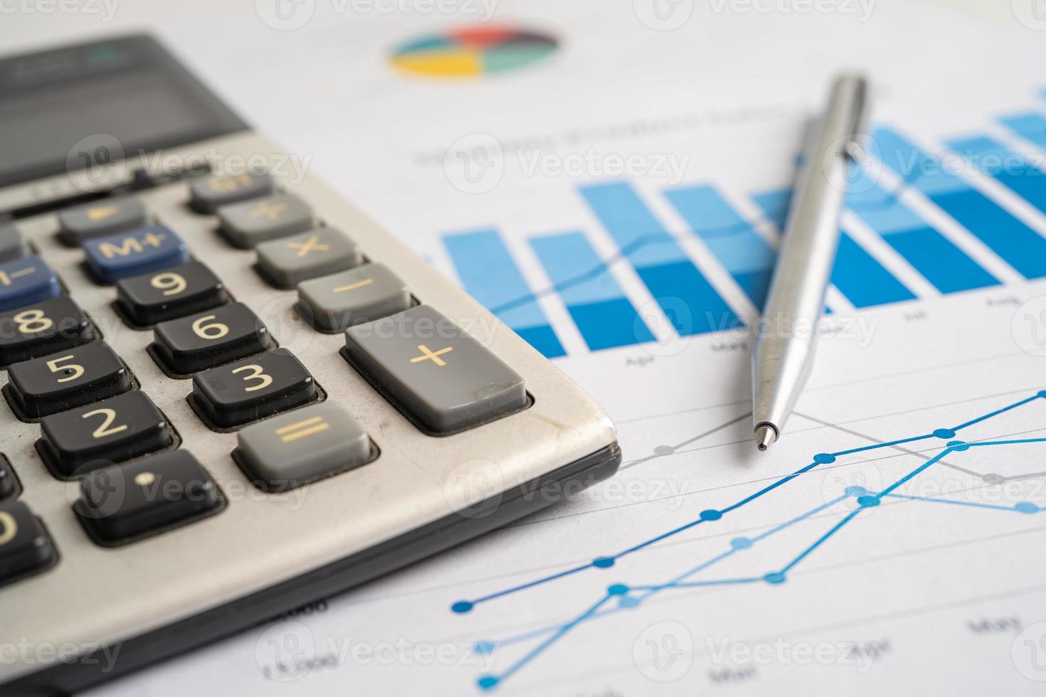 Calculator on chart and graph spreadsheet paper. Finance development, Banking Account, Statistics, Investment Analytic research data economy, Stock exchange trading, Business company concept. photo