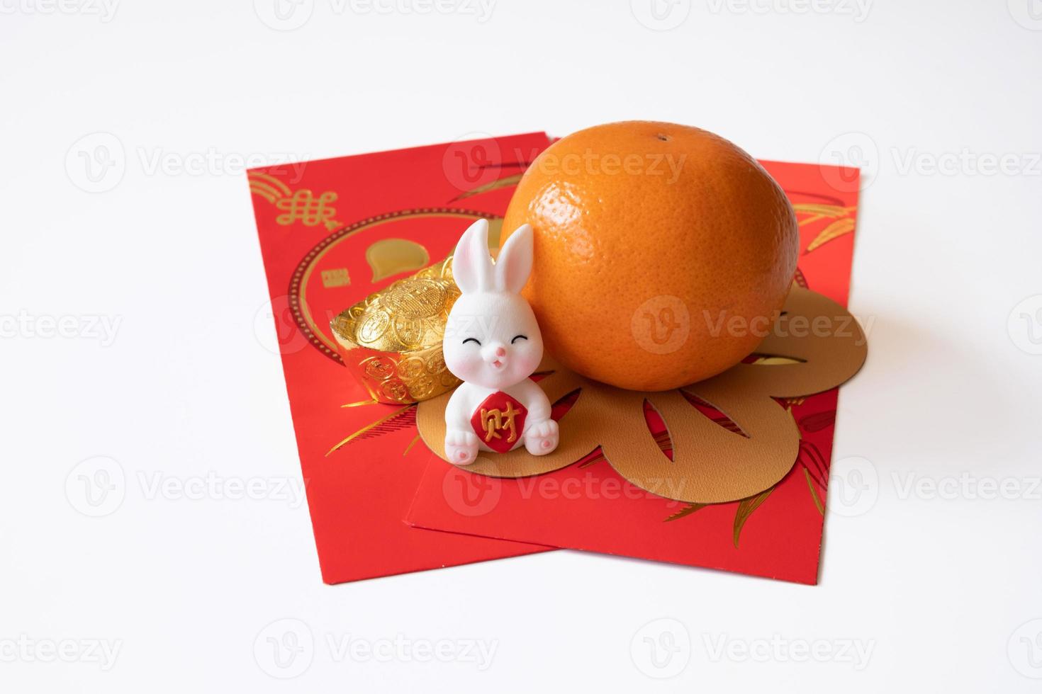 Chinese New Year of the rabbit festival concept. Mandarin orange,  rabbit and gold ingot isolated on white background. photo