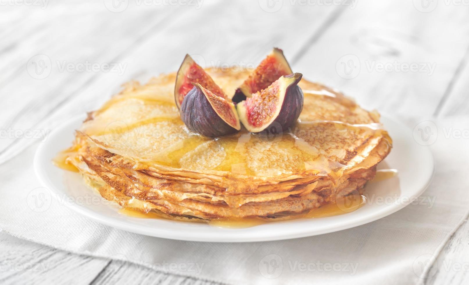 Stack of crepes on the white plate photo