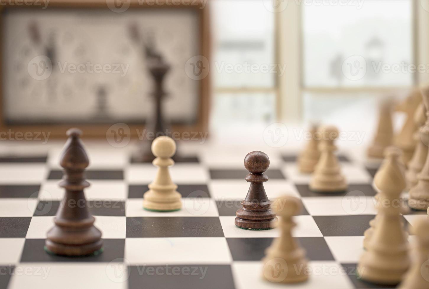 chess board with clock and figures in front of a blurry window photo