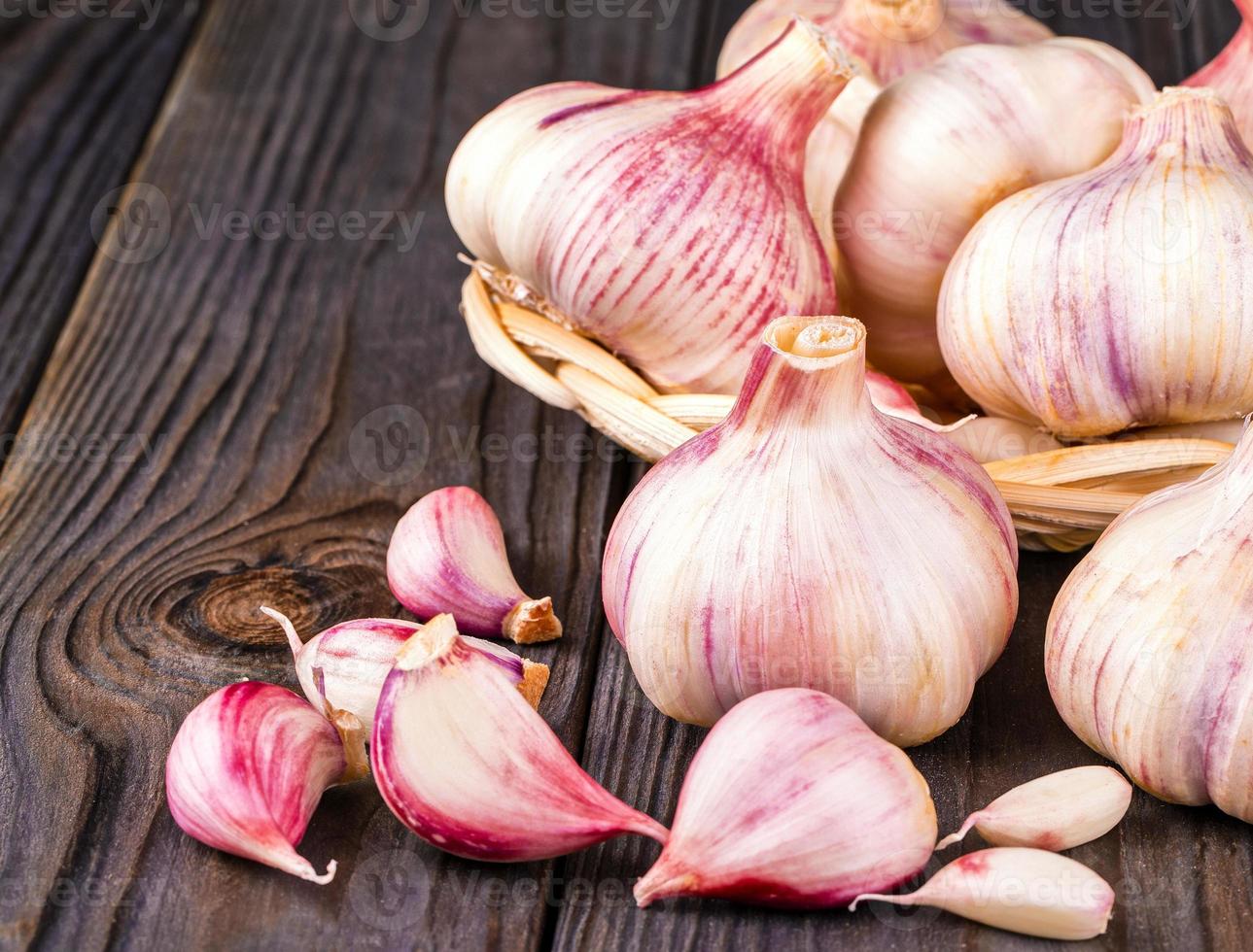 Garlic cloves and garlic bulb on a old wooden table photo