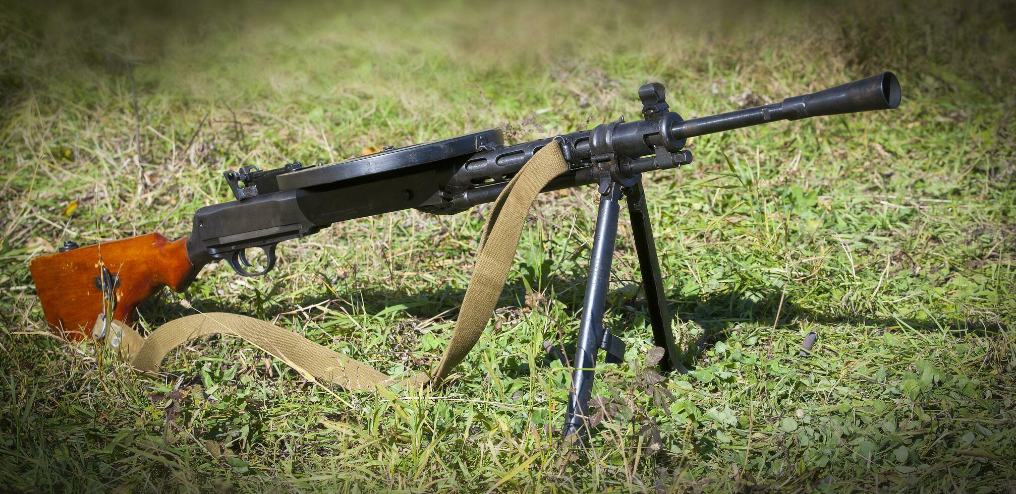 Soviet light machine gun on green grass. Close up photo