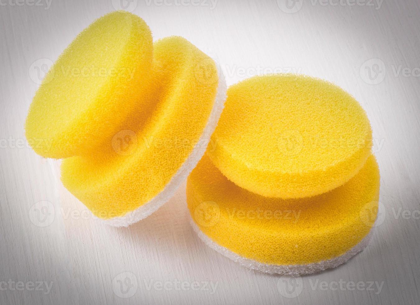 Yellow sponges for washing dishes on white backgroud photo