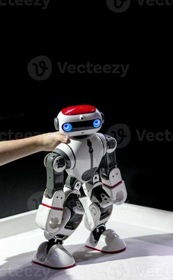 model robot in the hands of a child at the exhibition. Selective focus photo