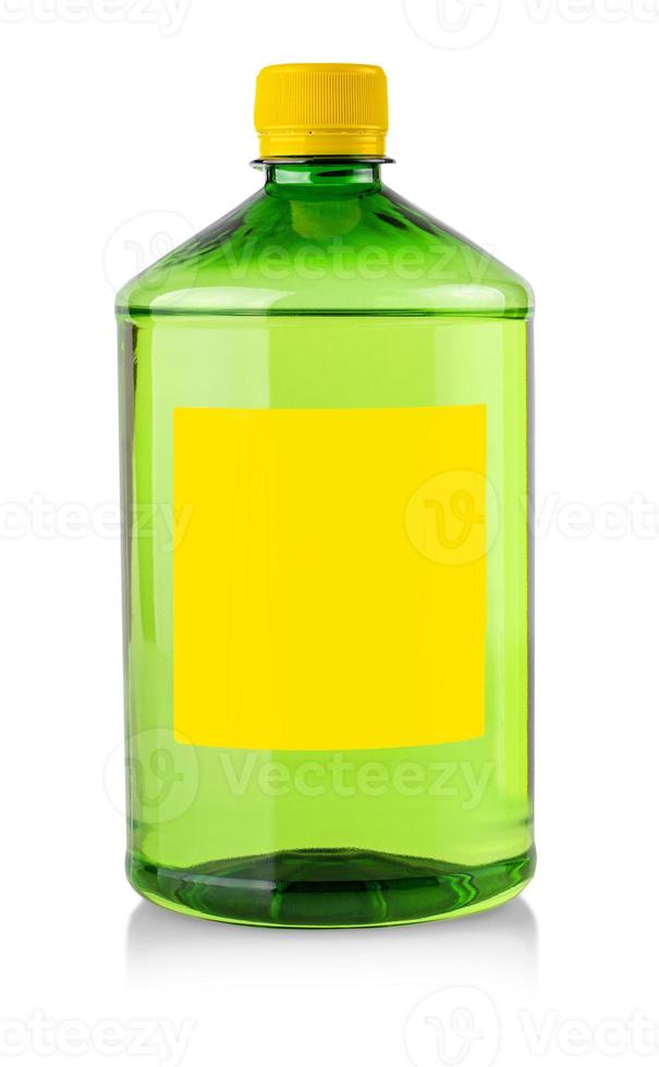 plastic transparent bottle with green chemical liquid with label on white photo