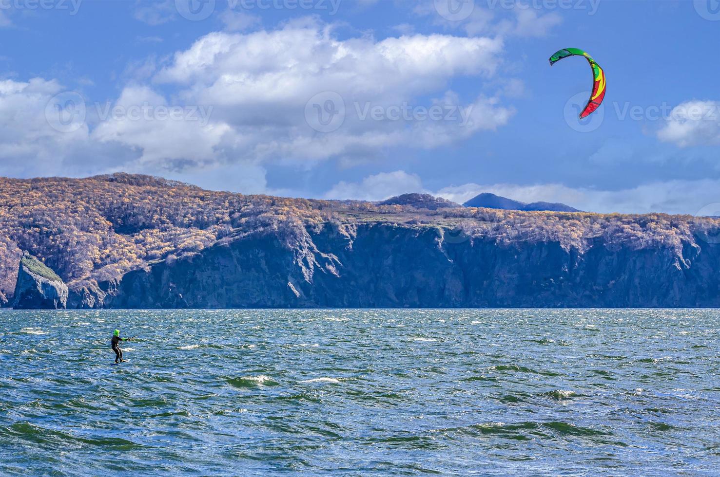 Kitesurfing on the waves in the Pacific Ocean off the coast of the Kamchatka Peninsula photo