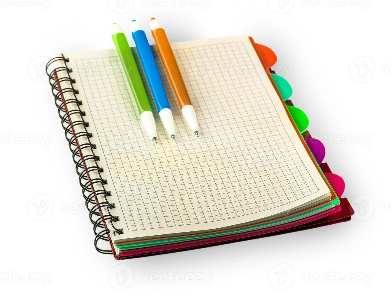 red Diary notebook and colored pens isolated on white background. photo