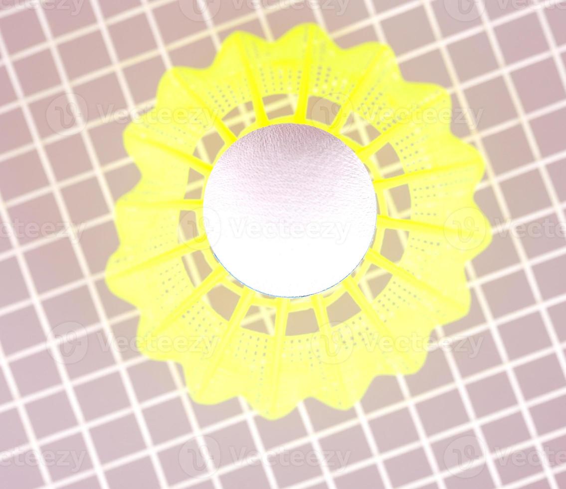 The Shuttlecock on badminton racket closeup photo