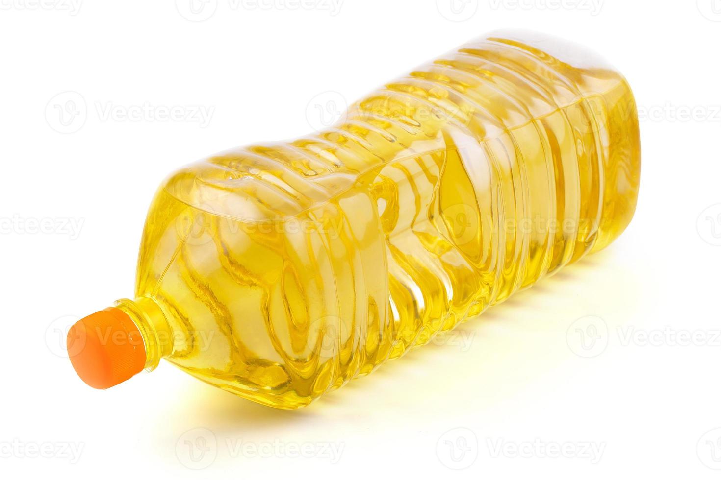 close up vegetable or sunflower oil in plastic bottle isolated on white photo