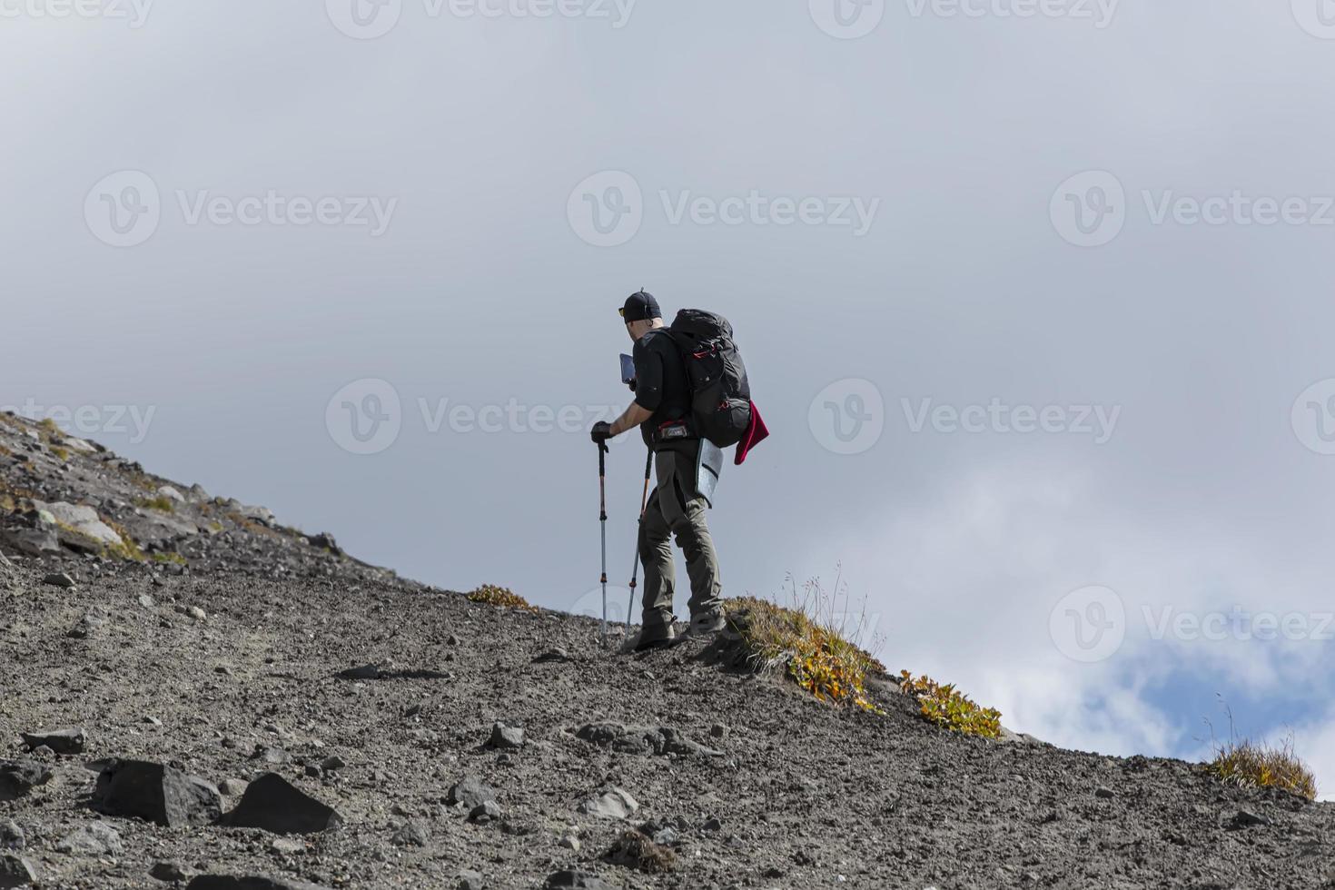 backpacker on the volcano and mountain on Kamchtka peninsula photo