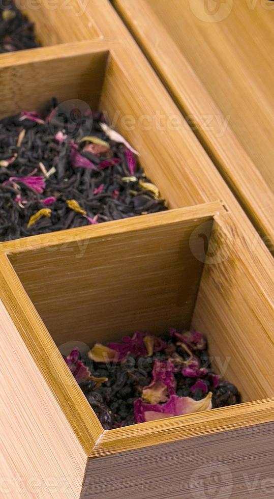 Wooden box with tea on white background. photo