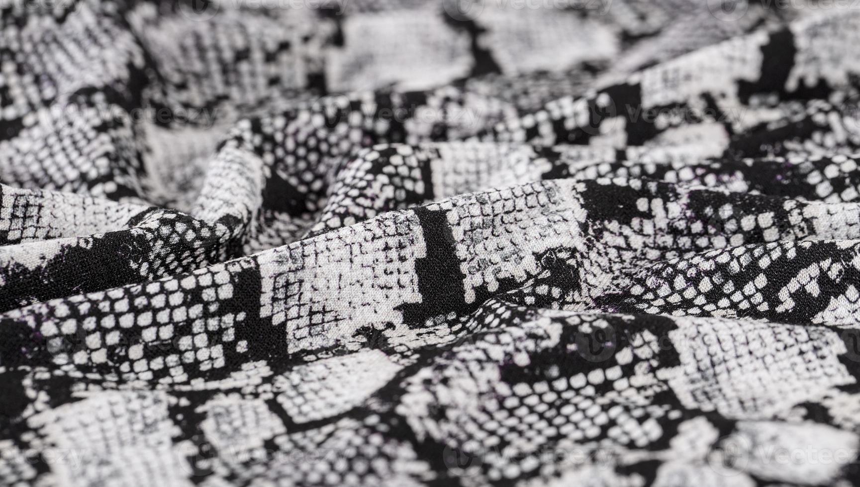 Black and white abstract camouflage. The concealment pattern on a fabric. photo