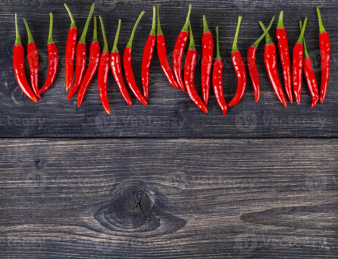 top view of spicy red chili pepper on wooden surface.Selective focus photo