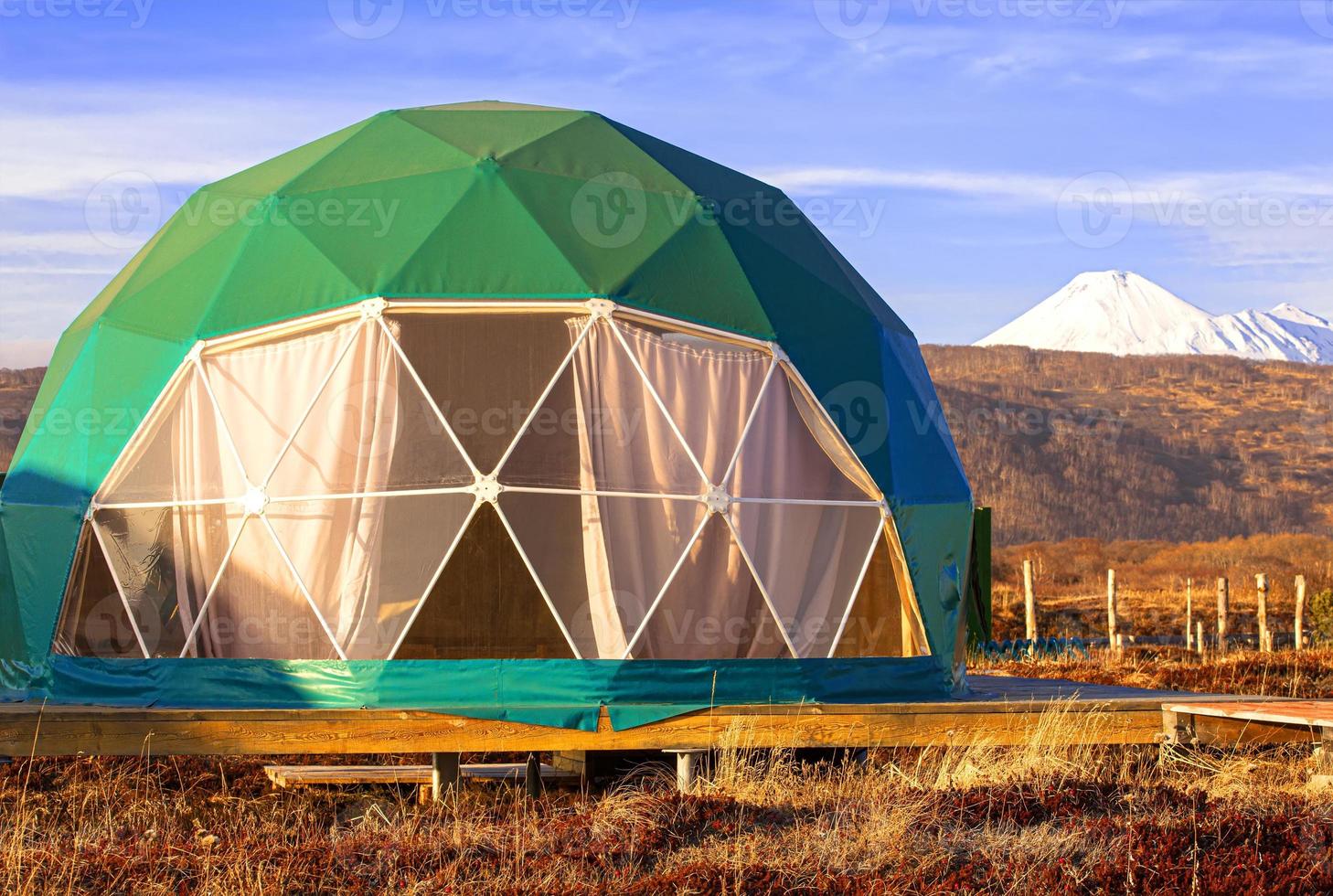 Green geo-dome tent on Kamchatka peninsula. Cozy, camping, glamping, holiday, vacation lifestyle concept. Outdoors cabin, scenic background photo