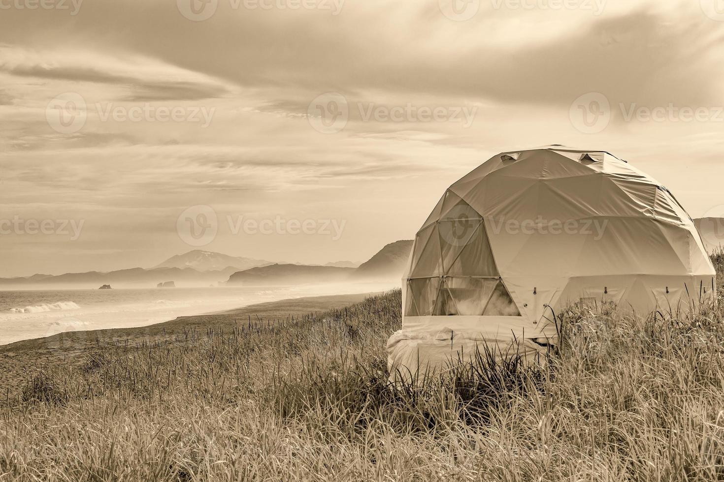 round glamping by the sea. black and white photo