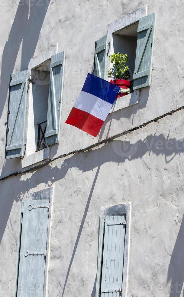 facade of the building with the flags of France in the window. photo