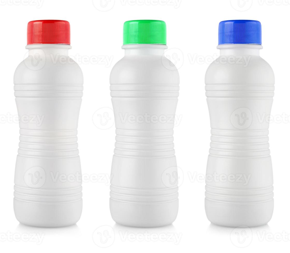 Opaque white plastic bottles with colored lidon white background photo