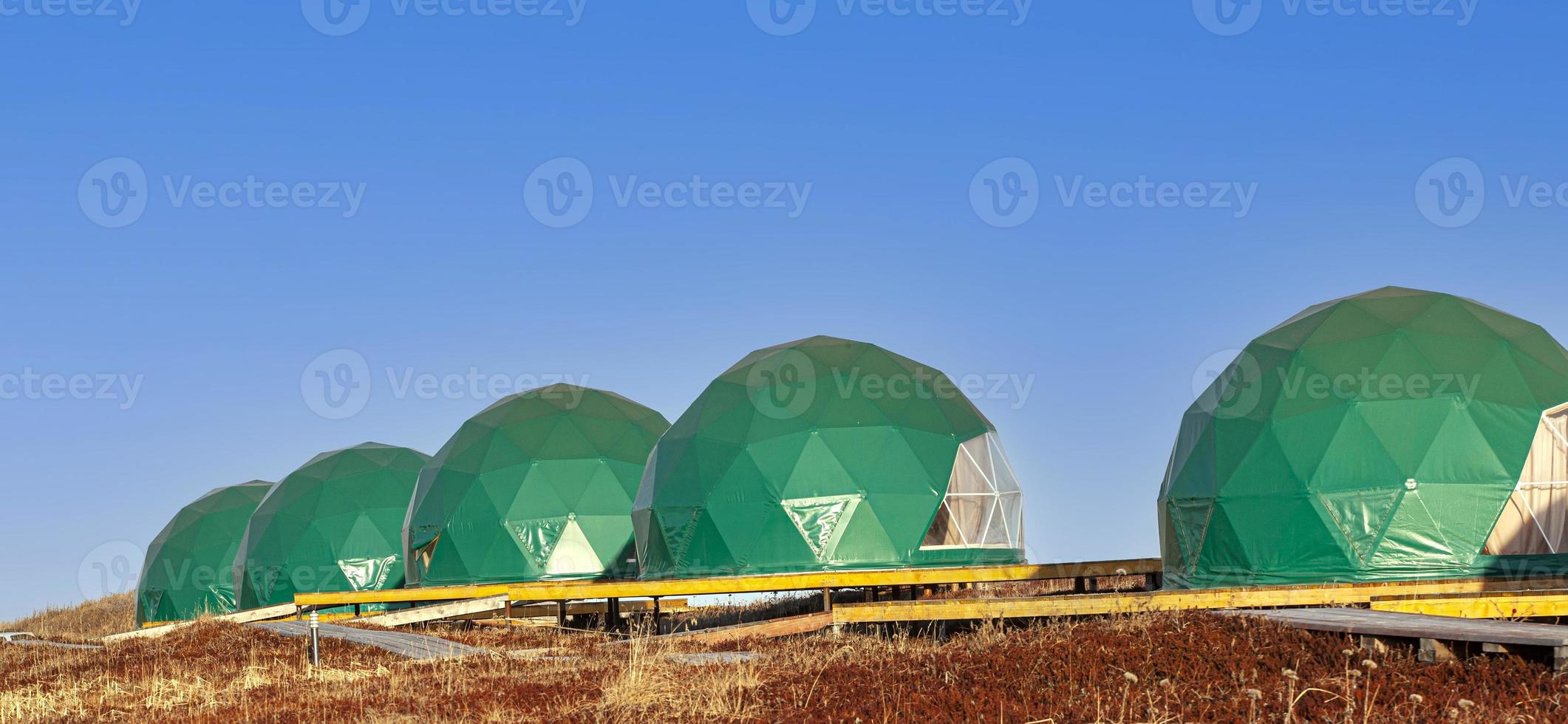 Green geo-dome tent on Kamchatka peninsula. Cozy, camping, glamping, holiday, vacation lifestyle concept. Outdoors cabin, scenic background photo